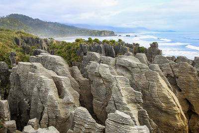 Panoramic view of rocks on land against sky