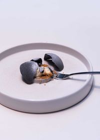 Close-up of dessert in plate on white background