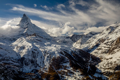 Scenic view of snowcapped mountains against sky