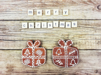 Close-up of text with christmas cookies on wood