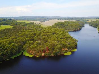 High angle view of river amidst trees against sky