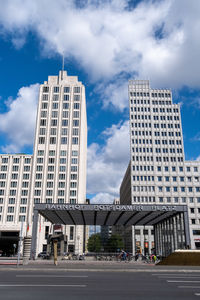 Low angle view of buildings against cloudy sky