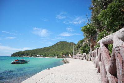 Scenic view of beach against blue sky