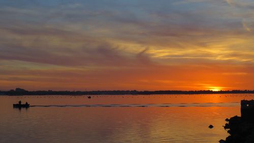 Scenic view of lake against sky during sunset