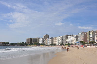 View of beach and buildings against sky