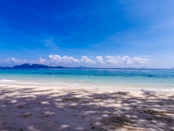 Scenic view of sea against blue sky