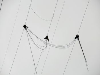 Low angle view of cables against sky