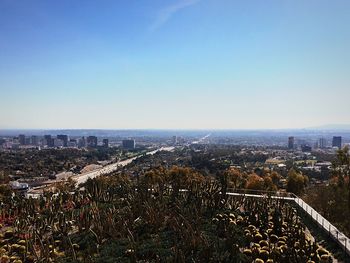 High angle view of cityscape against clear blue sky