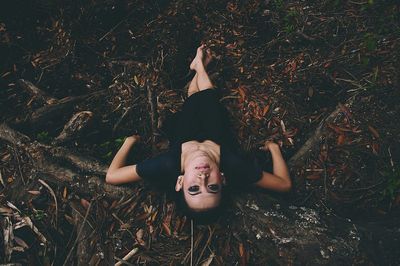 Portrait of young woman standing on grass