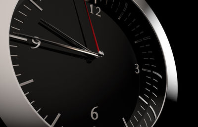 Close-up of clock against black background