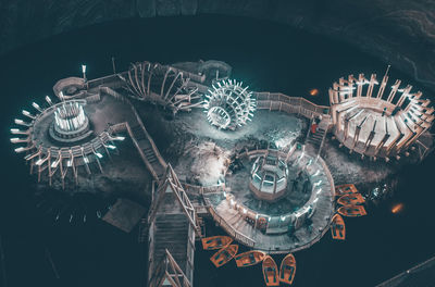 High angle view of illuminated lighting equipment hanging on glass