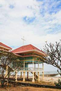 Exterior of house by building against sky