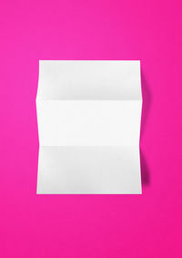 Directly above shot of empty paper against pink background