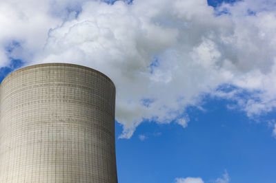 Low angle view of smoke stack against sky