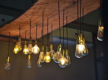 Illuminated light bulbs hanging from ceiling