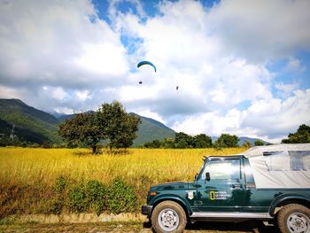 Vintage car on field against sky