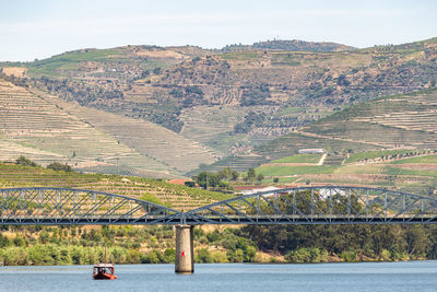 Scenic view of river by mountains against sky