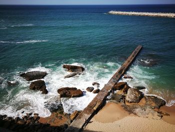 High angle view of rocks in sea against sky