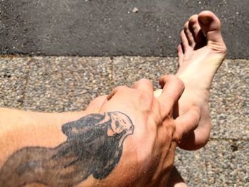 High angle view of man hand on street