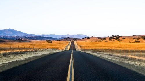 Country road leading towards mountains