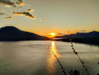 Scenic view of lake against sky during sunset