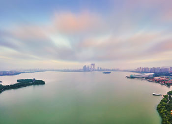 Panoramic view of city buildings against cloudy sky