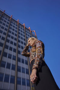 Woman standing against buildings