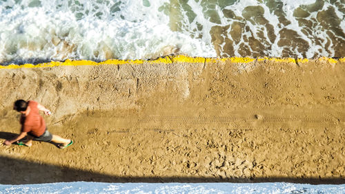 Full length of man surfing on beach