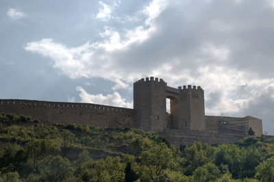 Low angle view of historic building against cloudy sky