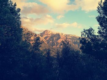 Scenic view of mountains against cloudy sky