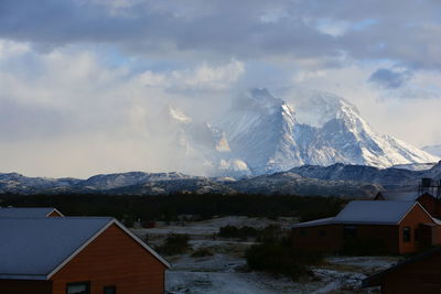 Houses against mountains during winter