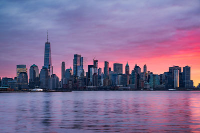 View of modern buildings in city at sunset