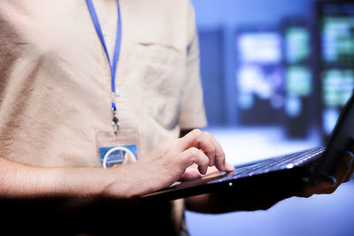 Midsection of man using mobile phone