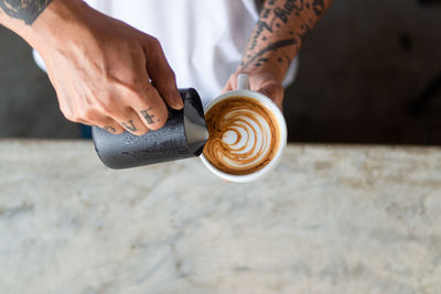 Midsection of man holding coffee