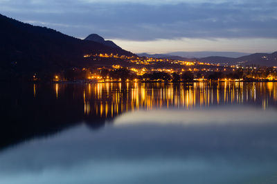 Scenic view of lake against sky at night