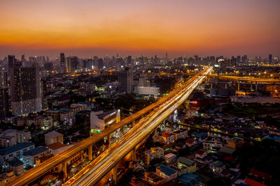 High angle view of illuminated buildings against sky at sunset