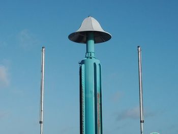 Low angle view of street light against blue sky