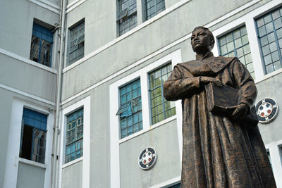 Low angle view of statue against building