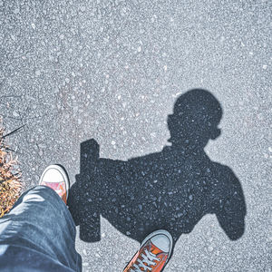 Low section of man standing on road