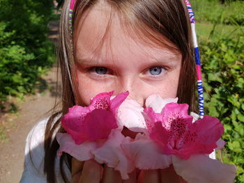 Close-up portrait of girl with pink flowers