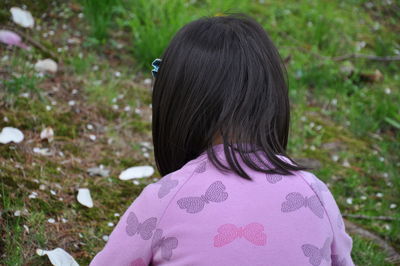 Rear view portrait of girl with pink petals