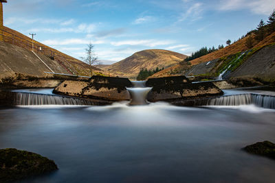 Long exposure view of river against sky