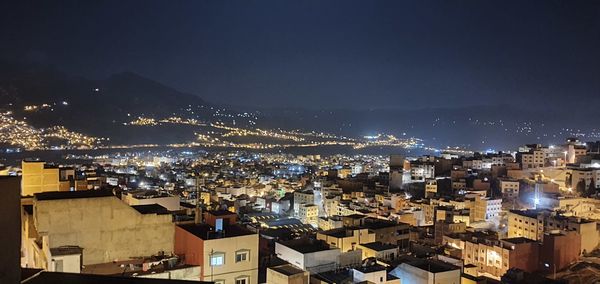 High angle view of illuminated buildings in city at night