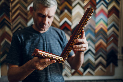 Midsection of man holding guitar