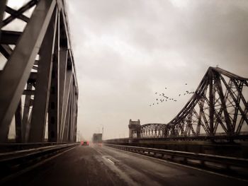 Bridge against sky in city