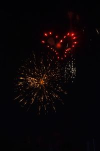 Low angle view of firework display at night