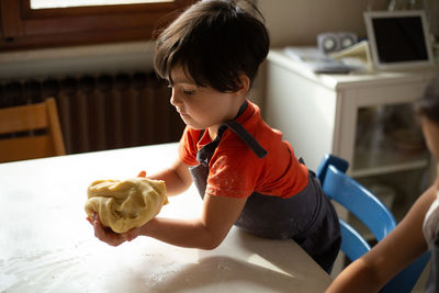 Side view of girl preparing food at home