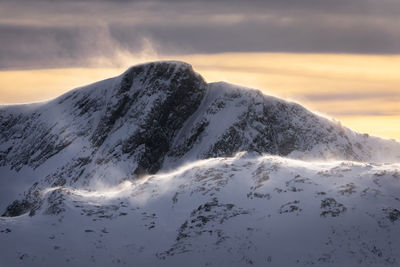 Scenic view of snow covered mountain against sky during sunset