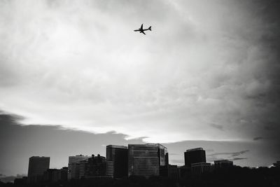 Low angle view of silhouette buildings against sky