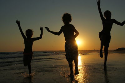 Silhouette of children playing on beach